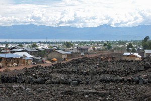 n January 2002, Nyiragongo erupted, sending a stream of lava 200 metres (219 yd) to one kilometre (1,100 yd) wide and up to two metres (6½ ft) deep through the center of the city as far as the lake shore. Agencies monitoring the volcano were able to give a warning and most of the population of Goma evacuated to Gisenyi. The lava destroyed 40% of the city (more than 4,500 houses and buildings).
