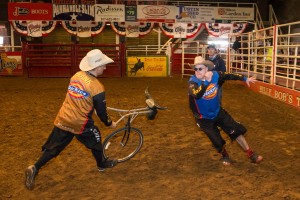 PHOTO 5-1: In the Texas ring, bull-fighter Frank Newsom teaches writer Jim Clash how to handle a charging bull using a mockup wheel. (Photo: Andy Gregory/Humps n Horns Magazine)