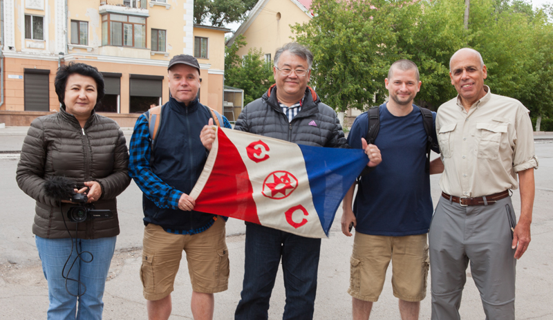 Nurlan holding the flag outside his office, where he donned a photo of the local boxer, his friend, Gennady Golovkin, world champion.